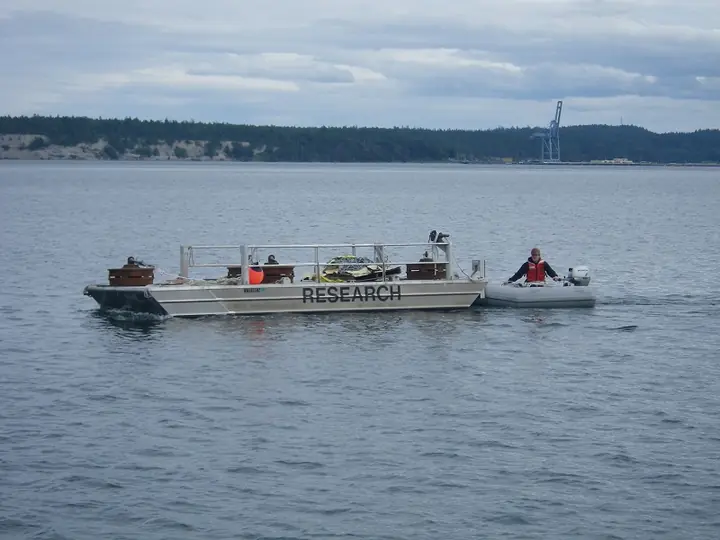 Aluminum research barge being maneuvered on the water