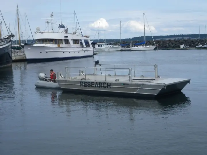 Aluminum research barge in a marina