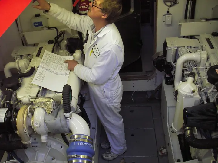 Marine engineer inspecting CASCADE engine-room machinery