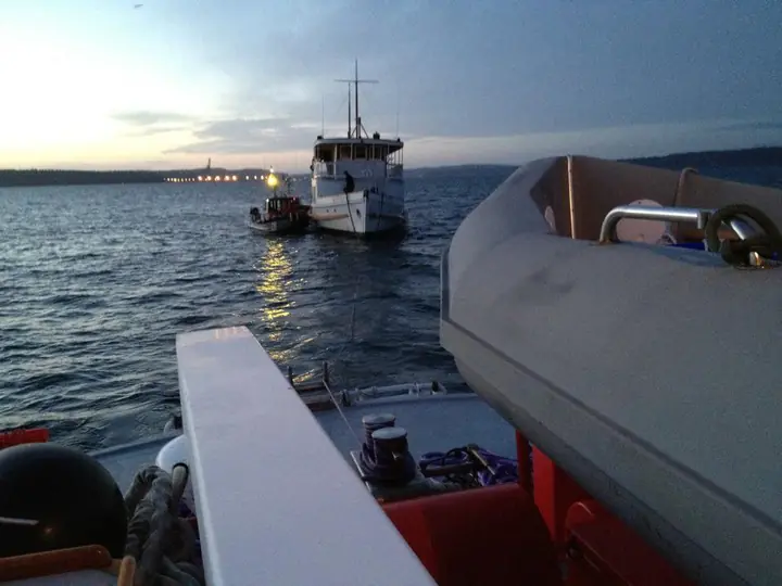 Tow operation viewed aft from CASCADE at dusk
