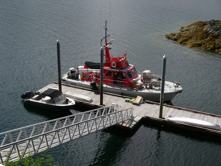 MAVERICK alongside CASCADE at a floating dock
